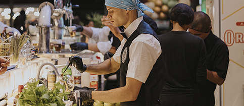 Detalhe visual da identidade Estação Praça aplicada em madeira